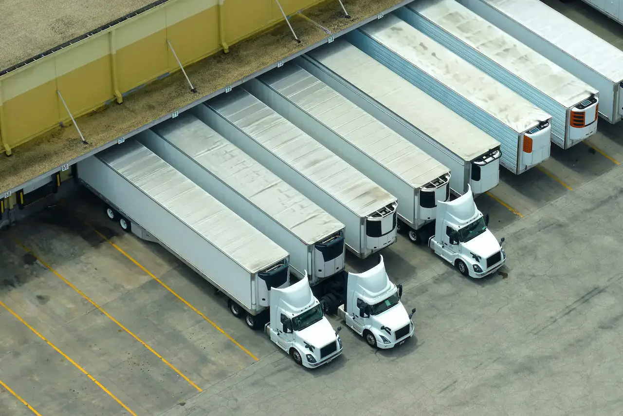 Flotte de camionnettes de livraison stationnées dans une cour d'entreprise